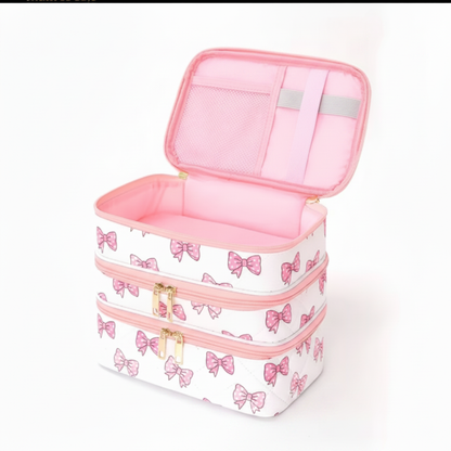 Pink bow travel makeup bag open showing interior compartments